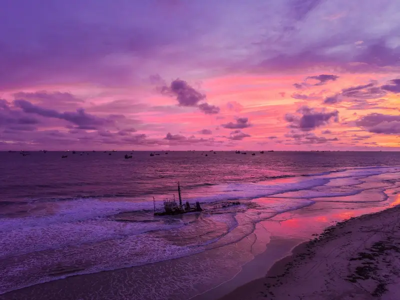 Sunrise over a shipwreck at Lighthouse Beach, Lagos